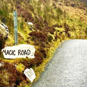 This is a photo of the Mamore Gap in Donegal, Ireland with a sign saying Magic Road.